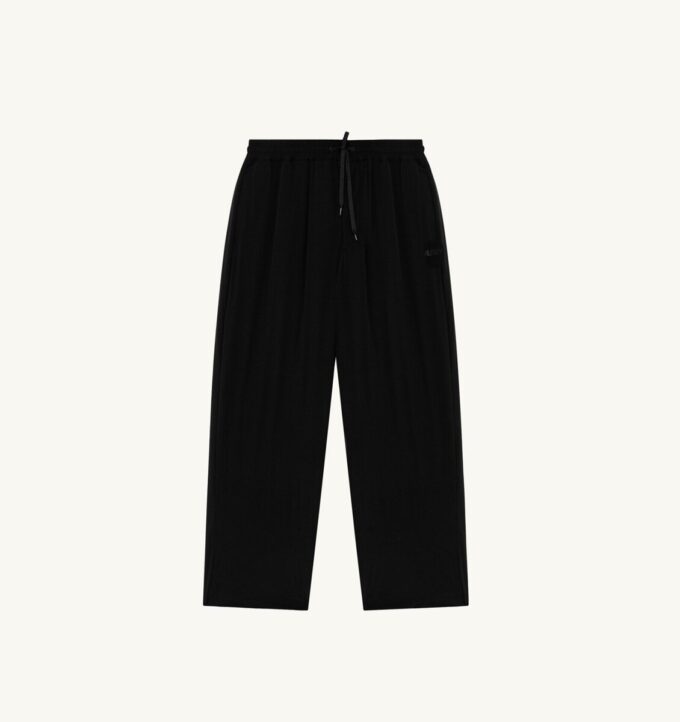 PANTALONES DE NYLON CON LOGO TONAL UNISEX PANTALONES DE NYLON CON LOGO TONAL UNISEX